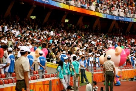 Spectators cheer at a Paralympic venue. 