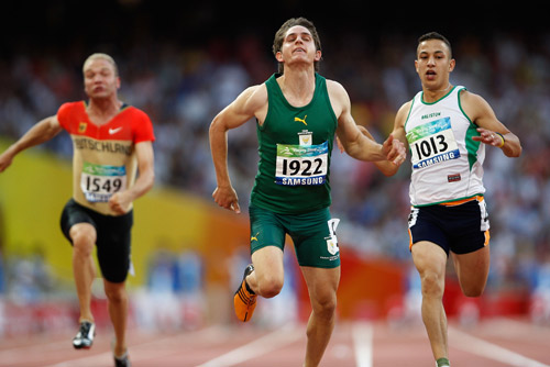 Fanie van der Merwe of South Africa (C) reaches the finish line. He claimed the Men's 100m-T37 gold medal with a time of 11.83 seconds at the National Stadium,also known as the Bird's Nest, during the Beijing 2008 Paralympic Games on September 12, 2008.