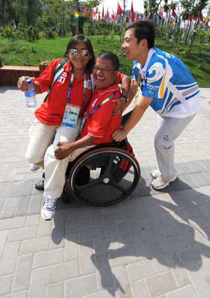 A volunteer helps members of the Mexican delegation at the Paralympic Village in Beijing Sept. 4, 2008. Some 44,000 volunteers are serving for the ongoing Beijing 2008 Paralympic Games and 90 percent of them have worked for the Olympic Games last month. 