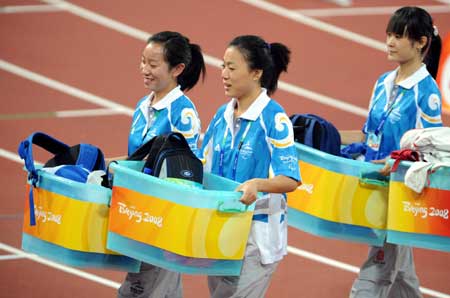 Volunteers work during a match of the Beijing Paralympic Athletics event at the National Stadium Sept. 10, 2008. 