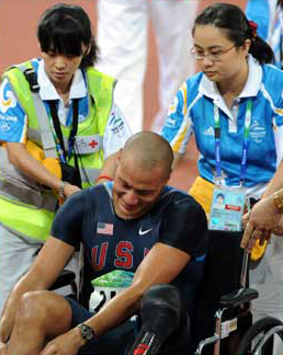 Volunteers help American athlete Marlon Shirley during a match of the Beijing Paralympic Athletics event at the National Stadium Sept. 9, 2008. 