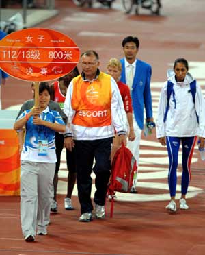 A volunteer guides athletes at the National Stadium Sept. 10, 2008. 