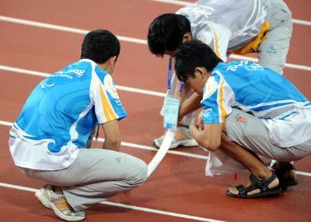 Volunteers work at the National Stadium in Beijing Sept. 10, 2008.