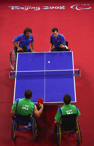 Jean-Phillippe Robin (blue, R2) serves.[Jamie McDonald/Getty Images]