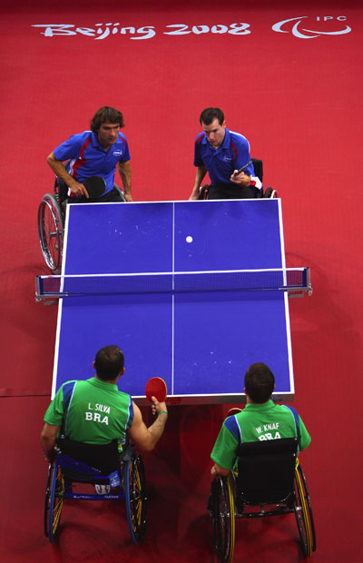 Jean-Phillippe Robin (blue, R2) serves. Jean-Philippe Robin and Florian Merrien of France beat Luiz Algacir Silva and Welder Knaf of Brazil 3-1 in the Men's Table Tennis Team Class 3 final at the Beijing 2008 Paralympic Games on September 15, 2008, claiming the gold medal. 