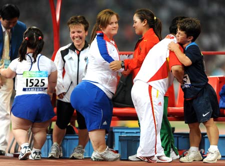 Athletes congratulate each other after women's shot put F40 final at the National Stadium, also known as the Bird's Nest,during the Beijing 2008 Paralympic Games in Beijing, Sept. 15, 2008. [Xinhua]