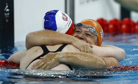 Mirjam de Koning-Peper (R) of the Netherlands is congratulated after the final of women's 50m freestyle S6 of Beijing 2008 Paralympic Games at the National Aquatics Center in Beijing, Sept. 15, 2008. Mirjam de Koning-Peper set a new world record and won the gold medal with a time of 35.60 secs.