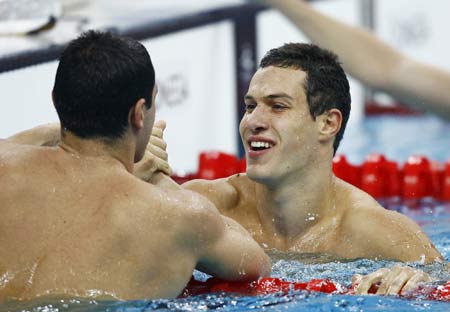 Oleksii Fedyna (R) of Ukraine is congratulated after winning the final of men's 50m freestyle S13 of Beijing 2008 Paralympic Games at the National Aquatics Center in Beijing, Sept. 15, 2008.Fedyna set a new world record and won the gold medal with a time of 23.75 secs.
