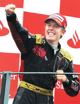 Toro Rosso's German driver Sebastien Vettel celebrates on the podium of the Monza racetrack on Sunday near Milan, after winning the Italian Formula One Grand Prix.