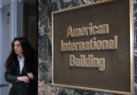 A woman exits the American International Building, world headquarters of American International Group (AIG) in New York, September 16, 2008, the United States. The Federal Reserve announced an 85 billion rescue loan to insurance giant American International Group (AIG). [Hou Jun/Xinhua] 
