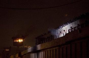 Towers of La Mesa State Prison burn as inmates riot in Tijuana, Mexico, Sunday, Sept. 14, 2008. Prisoners were angered by the alleged deaths of inmates at the hands of guards, and at least four prisoners were injured.[Guillermo Arias/AP] 