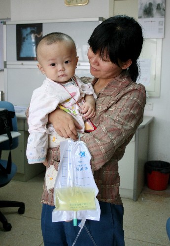 Nine-year-old Liu Xingyou receives treatment at a hospital in Southwest China's Guangxi Zhuang Autonomous Region on Tuesday, September 16, 2008. The baby, who had been fed the tainted Sanlu brand baby milk powder for seven months, was nearly killed by kidney stones and renal failure.