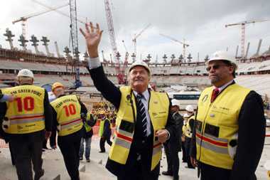 FIFA President Sepp Blatter (left) waves to people as a World Cup organizer Danny Jordaan (right) looks on during a visit to one of the 2010 World Cup stadiums in Cape Town on Monday.