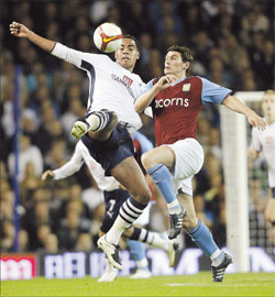 Tottenham Hotspurs’ Tom Huddlestone (left) challenges Aston Villa’s Gareth Barry during their English Premier League match at White Hart Lane in London on Monday. Villa won 2-1 to move up to fourth place.