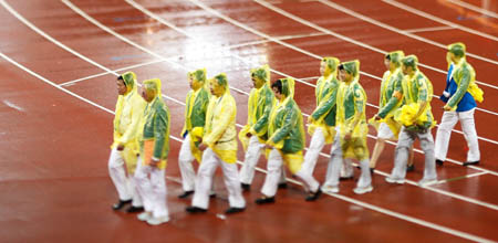 Umpires walk across the track in a line in a heavey rain at the National Stadium, also known as the Bird's Nest, during the Beijing 2008 Paralympic Games in Beijing, Sept. 16, 2008. 