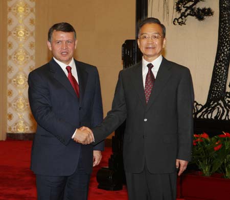 Chinese Premier Wen Jiabao (R) shakes hands with Jordanian King Abdullah II Bin Al-Hussein, who is on a two-day visit to China and attends the Beijing 2008 Paralympics closing ceremony, at the Great Hall of the People in Beijing, China, Sept. 17, 2008.