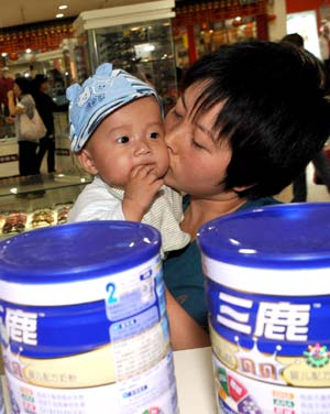 A woman and her baby return Sanlu brand milk powders in a supermarket in Yinchuan, capital of northwest China's Ningxia Hui Autonomous Region, Sept. 17, 2008.