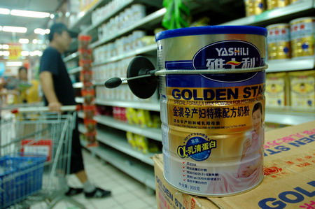 Cans of infant formula milk powder produced by Yashili, a dairy manufacturer based in south China's Guangdong Province, are removed from the shelves of a supermarket in Qingdao, east China's Shandong Province, September 17, 2008.