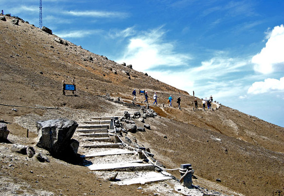 Visitors ascend the circular stone stairway leading to the lake.