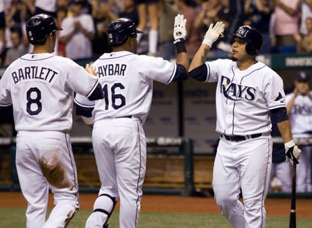 Tampa Bay Rays Dioner Navarro (R) congratulates WIlly Aybar (C) on his two-run home run against the Boston Red Sox during the first inning of their American League MLB baseball game in St. Petersburg, Florida September 17, 2008. At left is teammate Jason Bartlett.
