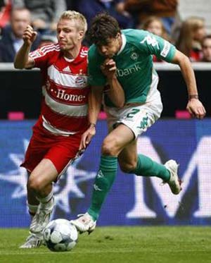 Bayern Munich's Christian Lell (L) fights for the ball with Werder Bremen's Sebastian Boenisch during their German Bundesliga first division soccer match in Munich, September 20, 2008. 