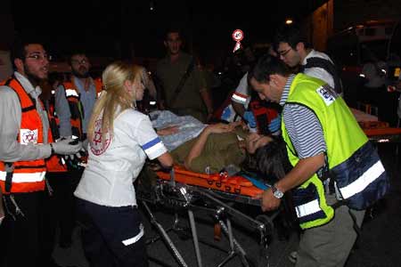 A wounded Israeli soldier is evacuated from the scene of an attack in Jerusalem September 22, 2008. 