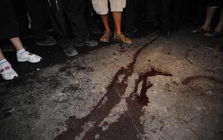 People gather at the scene of an attack in Jerusalem September 22, 2008.