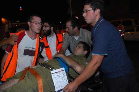 A wounded Israeli soldier is evacuated from the scene of an attack in Jerusalem September 22, 2008. 