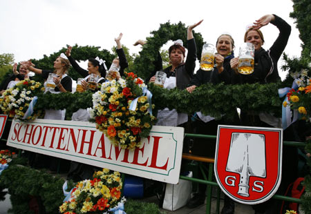 Women in traditional Bavarian clothes wave during the Oktoberfest parade in Munich September 20, 2008. Millions of beer drinkers from around the world come to the Bavarian capital Munich for the world&apos;s bigest and most famous beer festival, the Oktoberfest. The 175th Oktoberfest lasts from September 20 until October 5. [Xinhua]