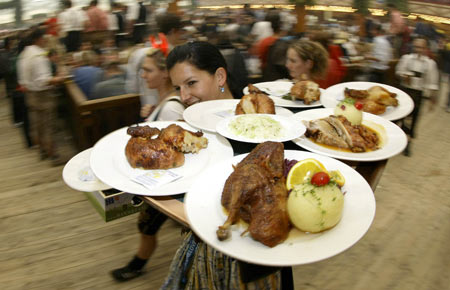 People toast with beer mugs during the opening ceremony of the first day at Munich&apos;s 175th Oktoberfest in Munich September 20, 2008. Millions of beer drinkers from around the world will come to the Bavarian capital Munich for the world&apos;s biggest and most famous beer festival, the Oktoberfest. [Xinhua]