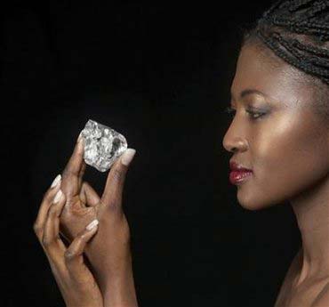 A model holds a white diamond weighing nearly 500 carats in this undated handout photograph released in London on September 21, 2008.