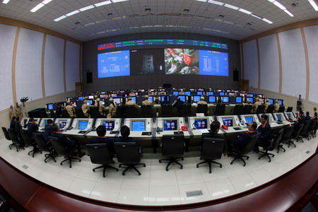Engineers monitor the operations of the Shenzhou-7 spacecraft mission during a joint drilling of all systems in Dongfeng Command and Control Center, Jiuquan Satellite Launch Center in Northwest China's Gansu Province September 22, 2008.