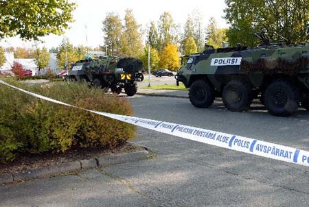 Police use the Finnish Army&apos;s armoured personnel carriers to seal the area around a school in Kauhajoki where a student shot dead several people before shooting himself September 23, 2008.