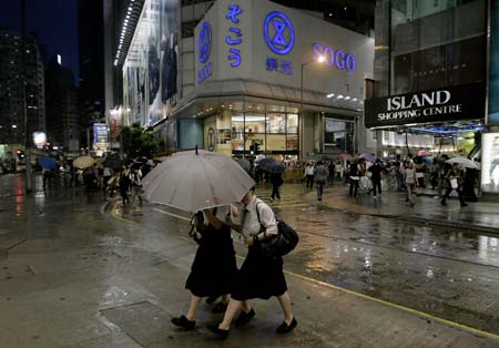 Pedestrians walk against heavy wind and rain on a street in Hong Kong, south China, Sept. 23, 2008. Hagupit, the 14th typhoon to affect China this year, is poised for landfall in the southern Guangdong Province on Wednesday, meteorological stations in Fujian and Guangdong provinces warned on Monday. (Xinhua/Zhou Lei)