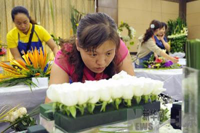 A contestant arranges flowers in this photo published on Monday, September 22, 2008. Over 100 flora artists took part in the flower-arranging competition held in Shunyi district of Beijing on Monday. The district will host the 7th China Flower Expo on September 26, 2009.