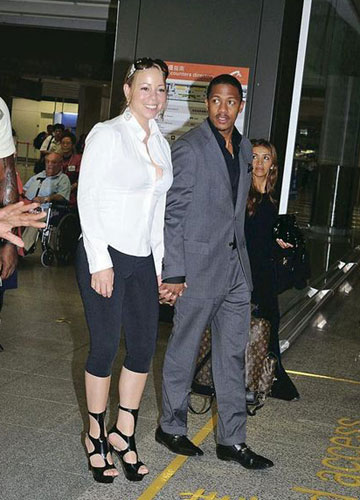 Mariah Carey and her husband, Nick Cannon, arrive at the Hong Kong airport on September 23, 2008.