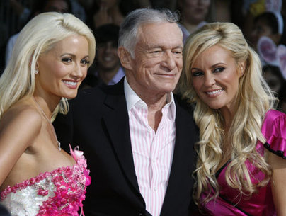 Cast members Hugh Hefner (C), Holly Madison (L) and Bridget Marquardt of the comedy film 'The House Bunny' pose at the film's premiere in Los Angeles August 20, 2008.
