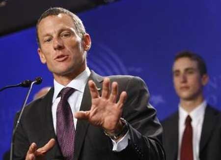 Cyclist Lance Armstrong answers a question at a news conference as young rider Tayler Phinney (R) listens during the Clinton Global Initiative, in New York on Wednesday, Sept. 24, 2008. 
