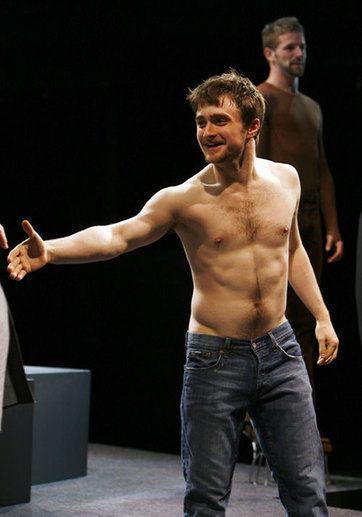 Actor Daniel Radcliffe reaches for the hand of a fellow actor during a curtain call after the opening night of the play 'Equus' at the Broadhurst Theater in New York, September 25, 2008.