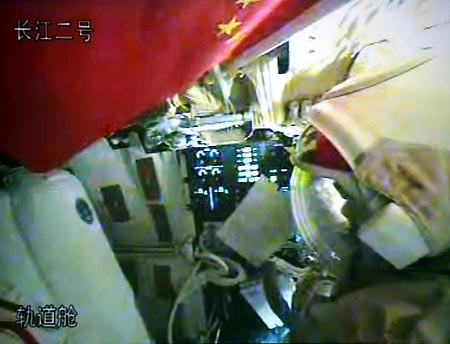 Chinese taikonauts Zhai Zhigang and Liu Boming try their space suits in the orbit module of the Shenzhou-7 spacecraft, in this video grab taken on Sept. 26, 2008. The Shenzhou-7 spacecraft, which blasted off at 9:10 p.m. Thursday at the Jiuquan Satellite Launch Center in northwest China's Gansu Province, has functioned well as planned.
