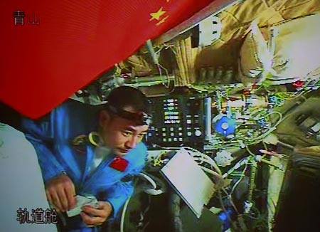 Chinese taikonaut Zhai Zhigang tries a bite on his food in the orbit module of the Shenzhou-7 spacecraft, in this video grab taken on Sept. 26, 2008. The Shenzhou-7 spacecraft, which blasted off at 9:10 p.m. Thursday at the Jiuquan Satellite Launch Center in northwest China's Gansu Province, has functioned well as planned.
