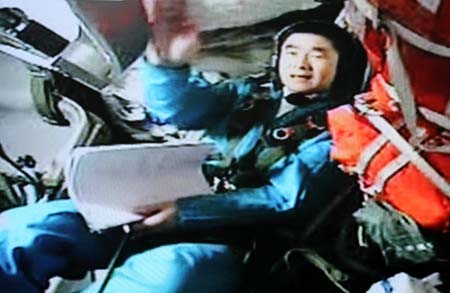 Blue-suited Chinese astronaut Liu Boming is on duty in the cabin of the Shenzhou VII spacecraft in this frame grab taken on the morning of September 26, 2008. Astronauts aboard the Shenzhou VII spacecraft, China&apos;s third manned spaceship, began to unpack and assemble the indigenous Feitian extra-vehicular activity (EVA) suit at 10:20 am Friday in preparation for China&apos;s first spacewalk. [CFP] 