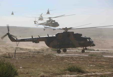 Special rescueing helicopters fly over the main landing field of the Shenzhou-7 spacecraft in Siziwang Banner (county), north China&apos;s Inner Mongolia Autonomous Region, where the spacecraft is expected to land as it returns to the earth, on Sept. 26, 2008.