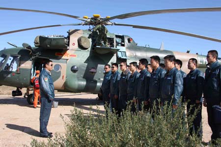 A colonel of special rescuing helicopters team addresses a mobilizing ceremony in the area awaiting for emergency missions of the main landing field of the Shenzhou-7 spacecraft in Siziwang Banner (county), north China&apos;s Inner Mongolia Autonomous Region, where the spacecraft is expected to land as it returns to the earth, on Sept. 26, 2008. 