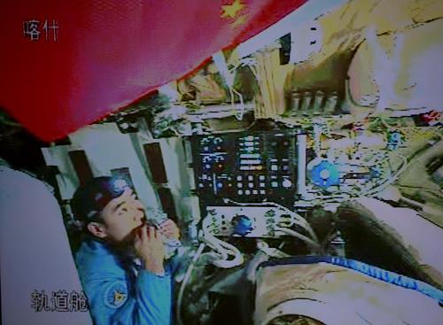 Chinese taikonaut Zhai Zhigang tries a bite on his food in the orbit module of the Shenzhou-7 spacecraft, in this video grab taken on Sept. 26, 2008.