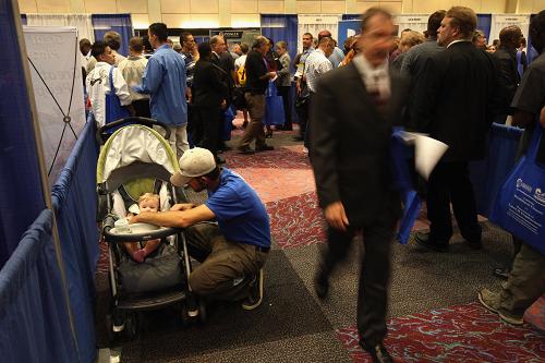 Hundreds of people wait to register at a state sponsored job fair September 25, 2008 in Denver, Colorado. The U.S. Labor Department reported Thursday that new claims for unemployment benefits jumped last week to their highest level in seven years due to the slowing economy and the impact of hurricanes Gustav and Ike.