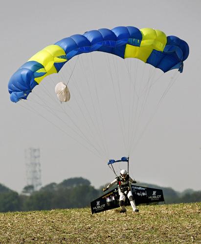 Swiss professional pilot Yves Rossy touches down in a field near Dover in southern England, after flying across the English Channel from France on September 26, 2008. Swiss adventurer Yves Rossy landed in Britain Friday after crossing the English Channel from France using only a jet-powered wing. [Xinhua]