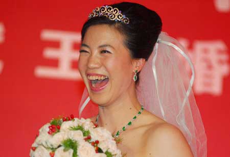 China's four-time Olympic table tennis gold medalist Wang Nan laughs at her wedding ceremony, Sept. 27, 2008.
