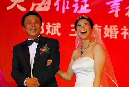 China's four-time Olympic table tennis gold medalist Wang Nan (R) laughs with her husband Guo Bin aboard a yacht to celebrate their wedding in Yantai, Shandong Province, Sept. 27, 2008. 