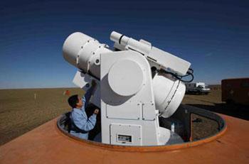 A staff member operates an optical record machine at the main landing field of the Shenzhou-7 spacecraft in Siziwang Banner (county), north China's Inner Mongolia Autonomous Region, where the spacecraft is expected to land as it returns to the earth, on Sept. 26, 2008.[Xinhua]